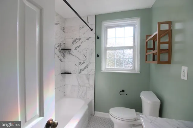 a bathroom with a toilet and a bathtub