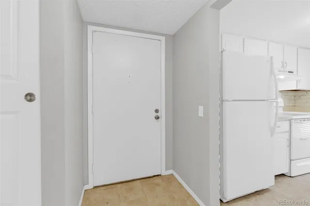 a view of walk in closet with white walls