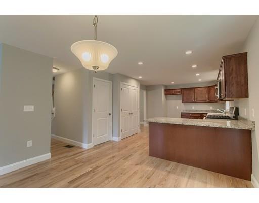 19 Goodale Street Haverhill, MA 01830 - Photo 5 of 30 a kitchen with stainless steel appliances granite countertop a refrigerator a sink and a stove