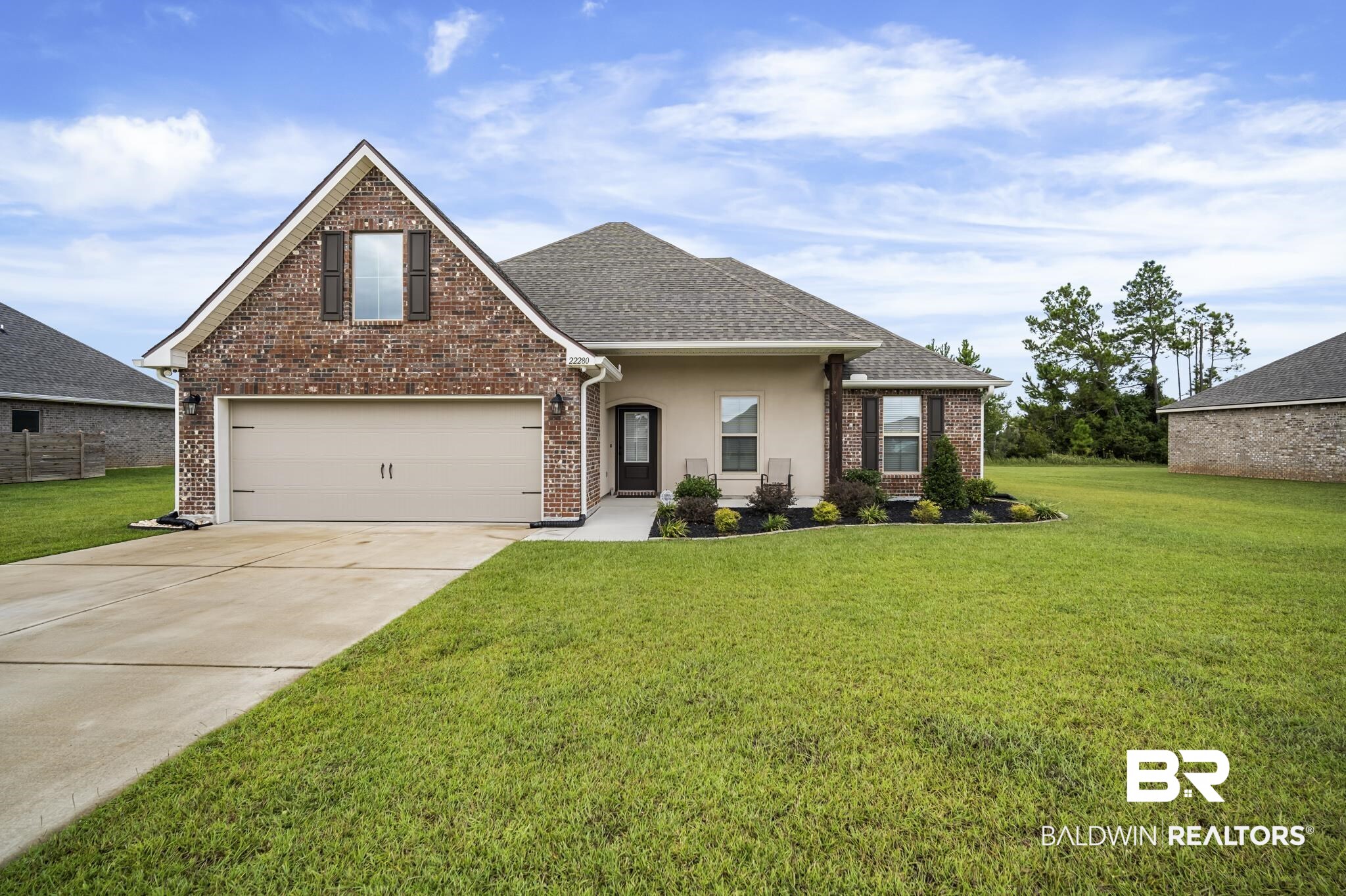 22280 Hibiscus Circle Foley, AL 36535 - Photo 1 of 8 View of front facade with a front yard, concrete driveway, brick siding, and roof with shingles