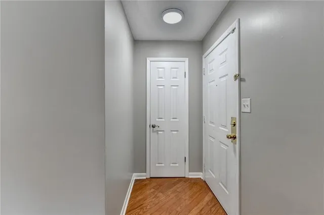 a living room with furniture a flat screen tv and a large window