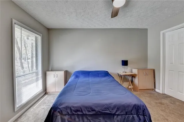 a bedroom with furniture and window
