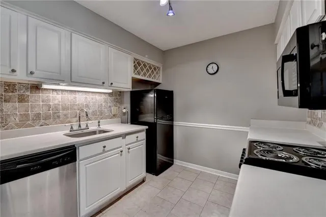 a kitchen with a sink and a stove top oven