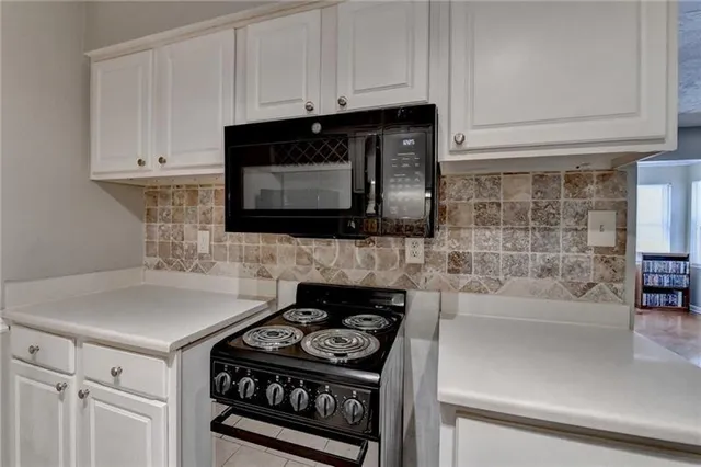 a kitchen with stainless steel appliances a stove a microwave and cabinets