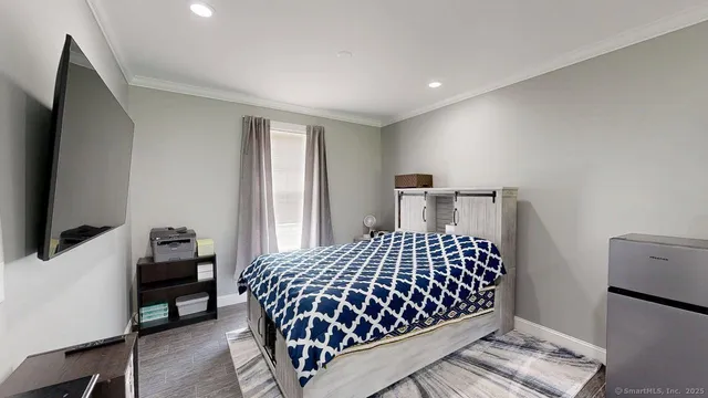 a bedroom with furniture and a window