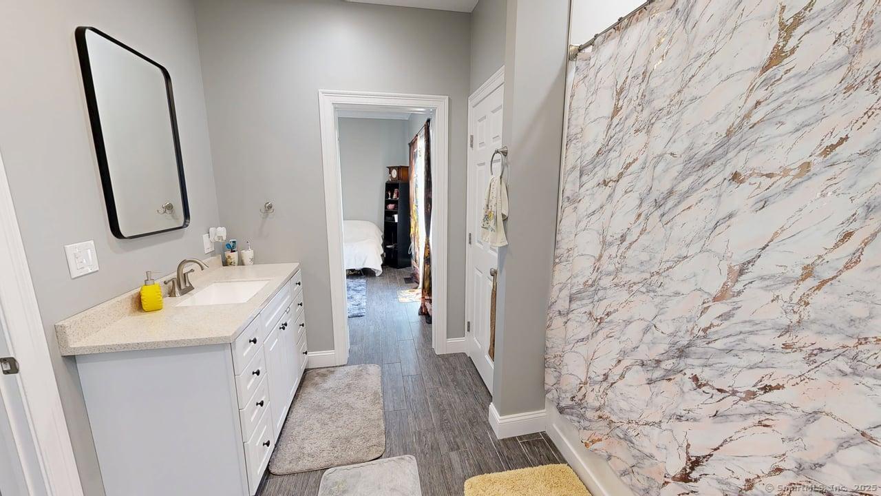 435 Maple Avenue Cheshire, CT 06410 - Photo 20 of 37 a bathroom with a sink a toilet and a mirror
