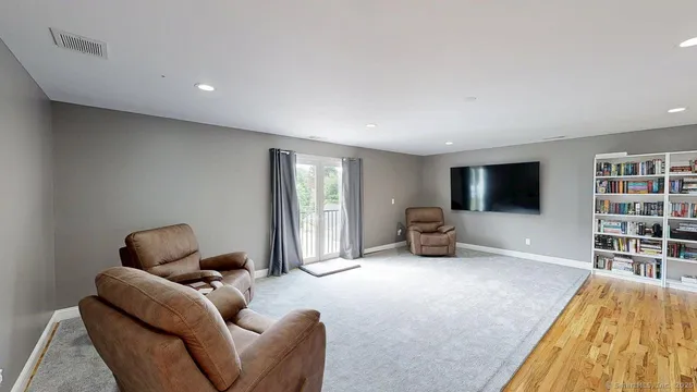a living room with dining room and wooden floor