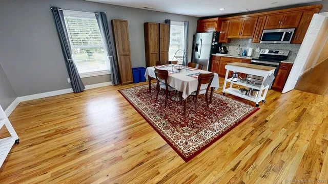 a living room with furniture a rug and a flat screen tv