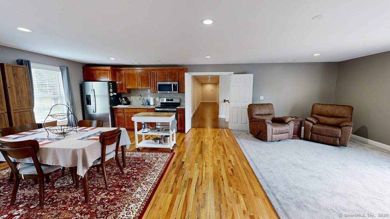 435 Maple Avenue Cheshire, CT 06410 - Photo 23 of 37 a living room with furniture a rug and a flat screen tv