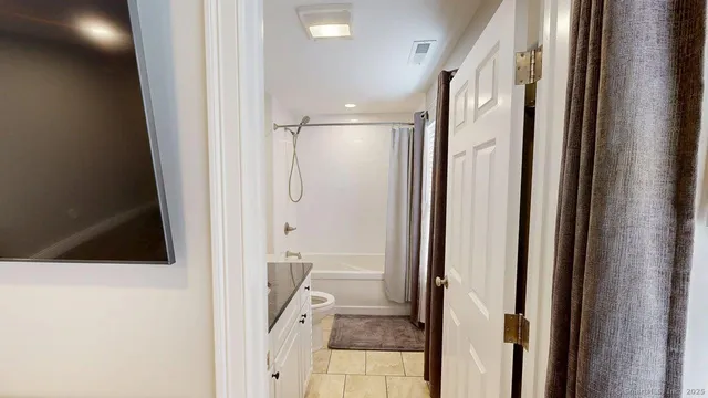 a bedroom with furniture and a large window