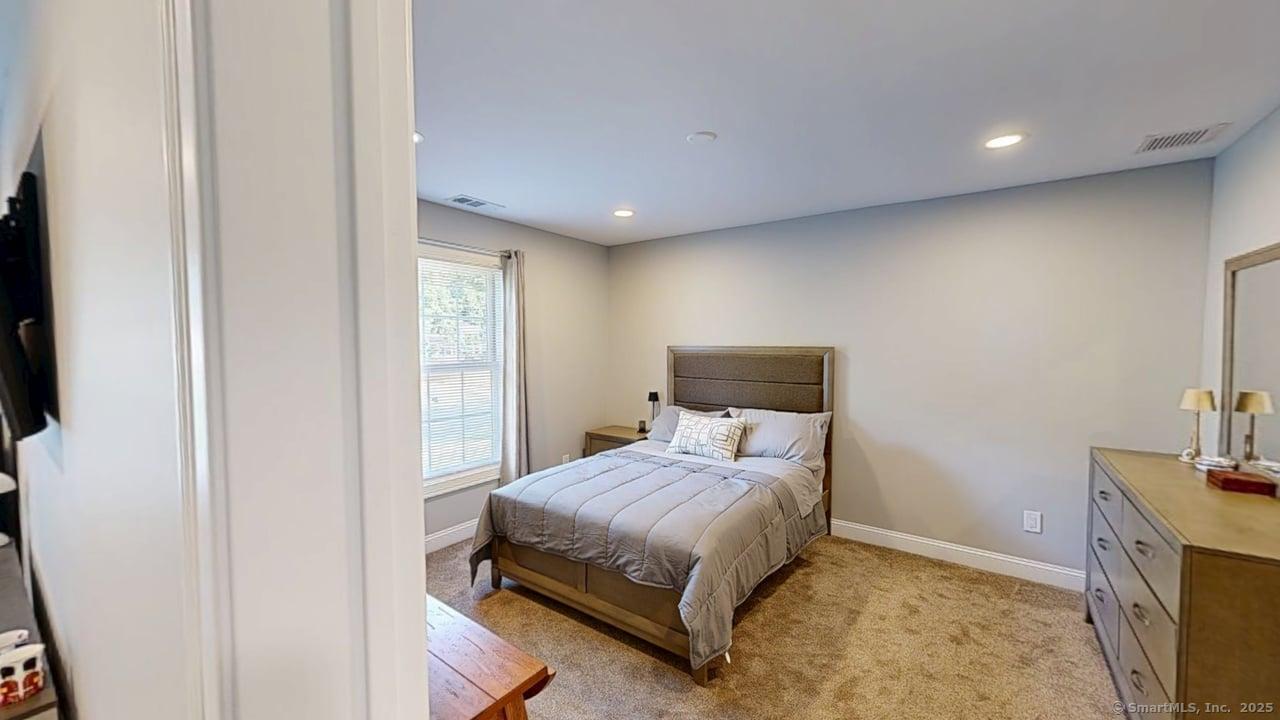 435 Maple Avenue Cheshire, CT 06410 - Photo 30 of 37 a bedroom with a bed and a flat tv screen on dresser