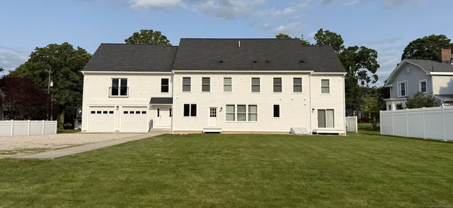 a view of house with a yard