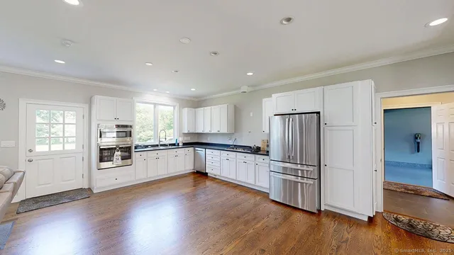 a kitchen with a refrigerator and a stove top oven