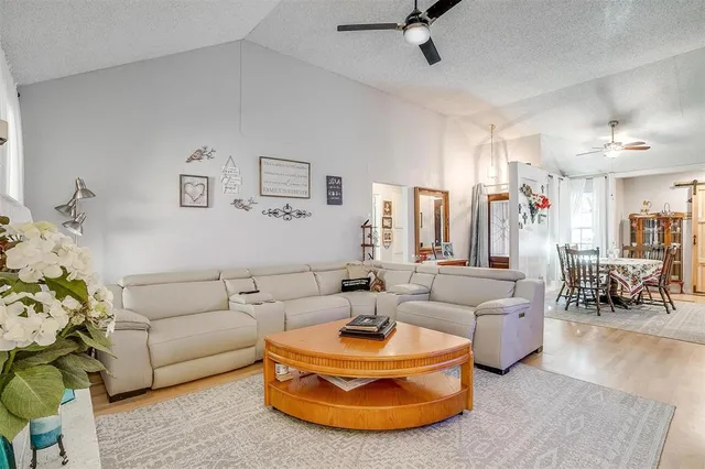 a living room with furniture and a chandelier