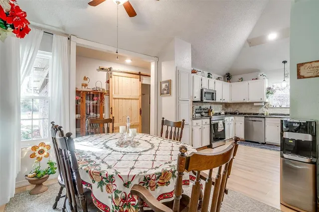 a view of a dining room with furniture and chandelier