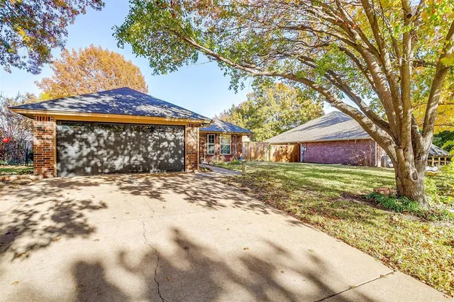 a front view of a house with a yard covered with snow