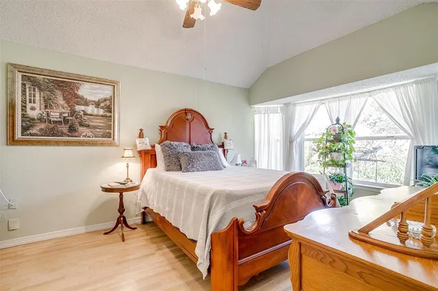 a bedroom with a bed and a large window