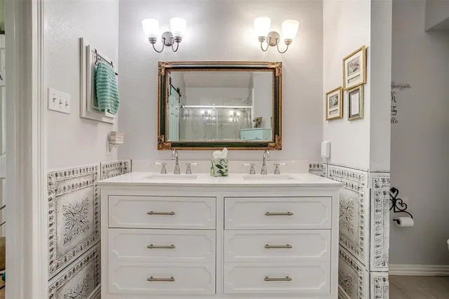 a bathroom with a double vanity sink and a mirror