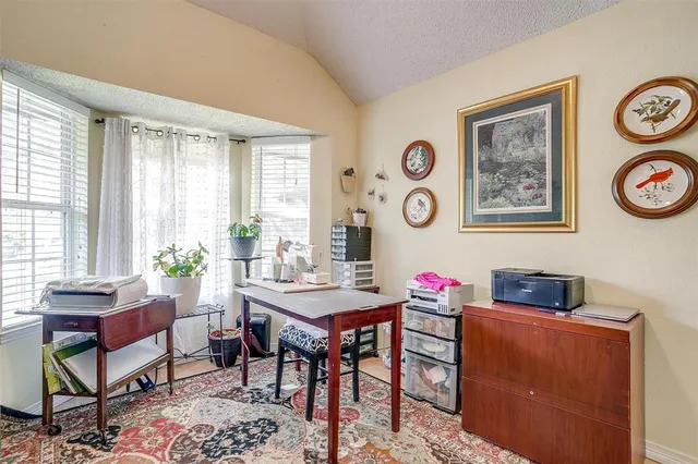 a view of a workspace with furniture and a window