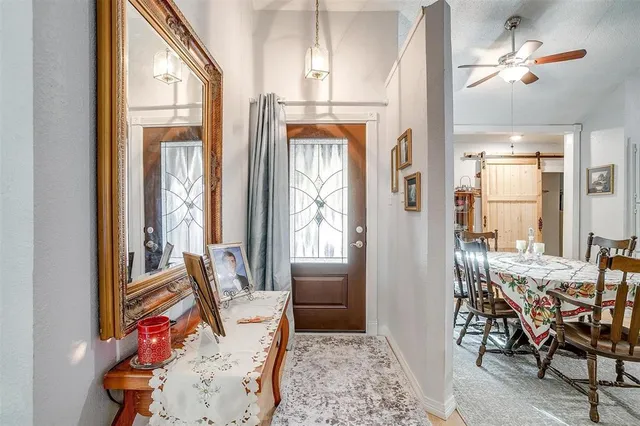 a view of a livingroom with furniture wooden floor and a chandelier
