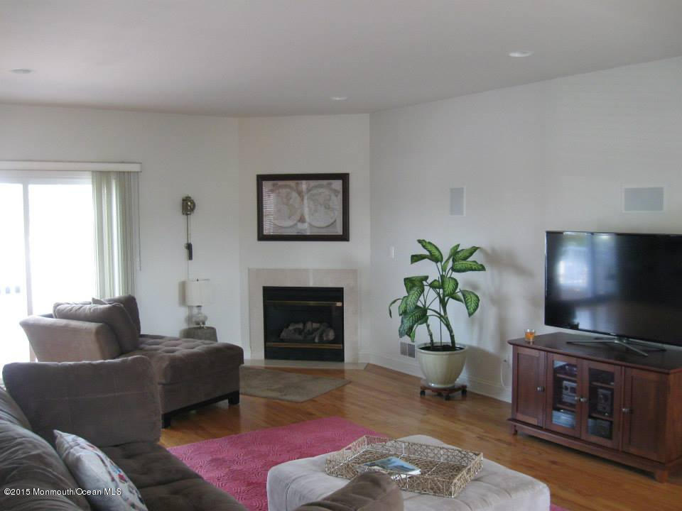 59 A Topsail Road Brick, NJ 08723 - Photo 4 of 18 a living room with furniture a fireplace and a flat screen tv