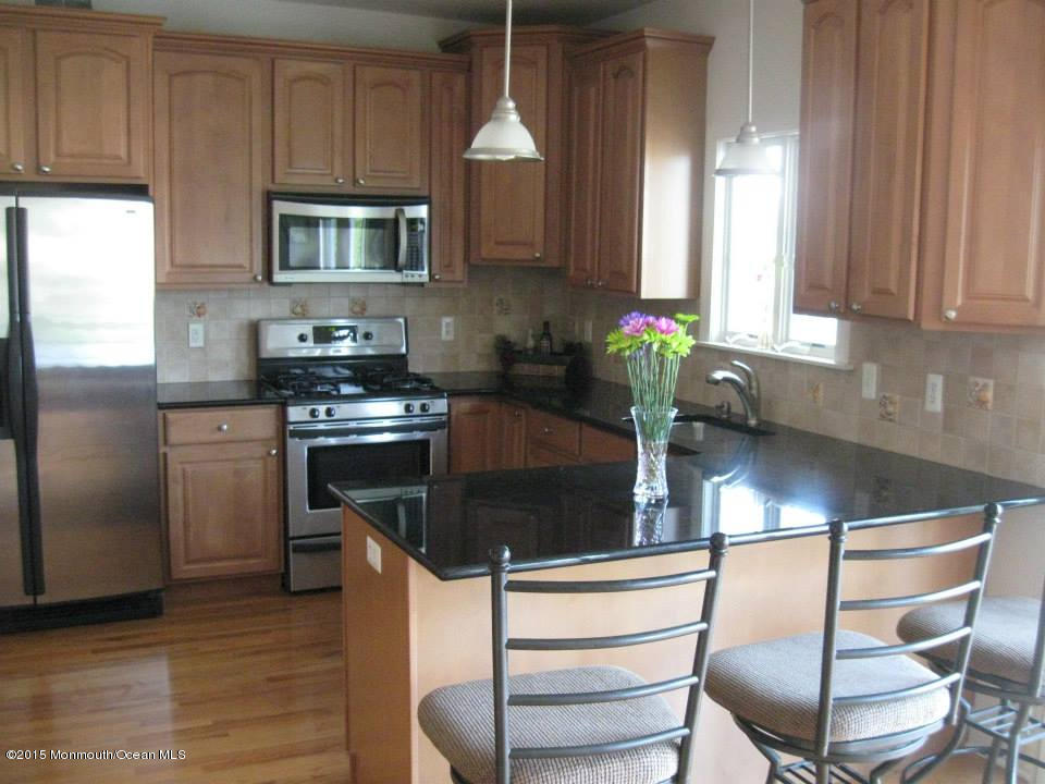 59 A Topsail Road Brick, NJ 08723 - Photo 6 of 18 a kitchen with stainless steel appliances granite countertop a stove a sink and a microwave