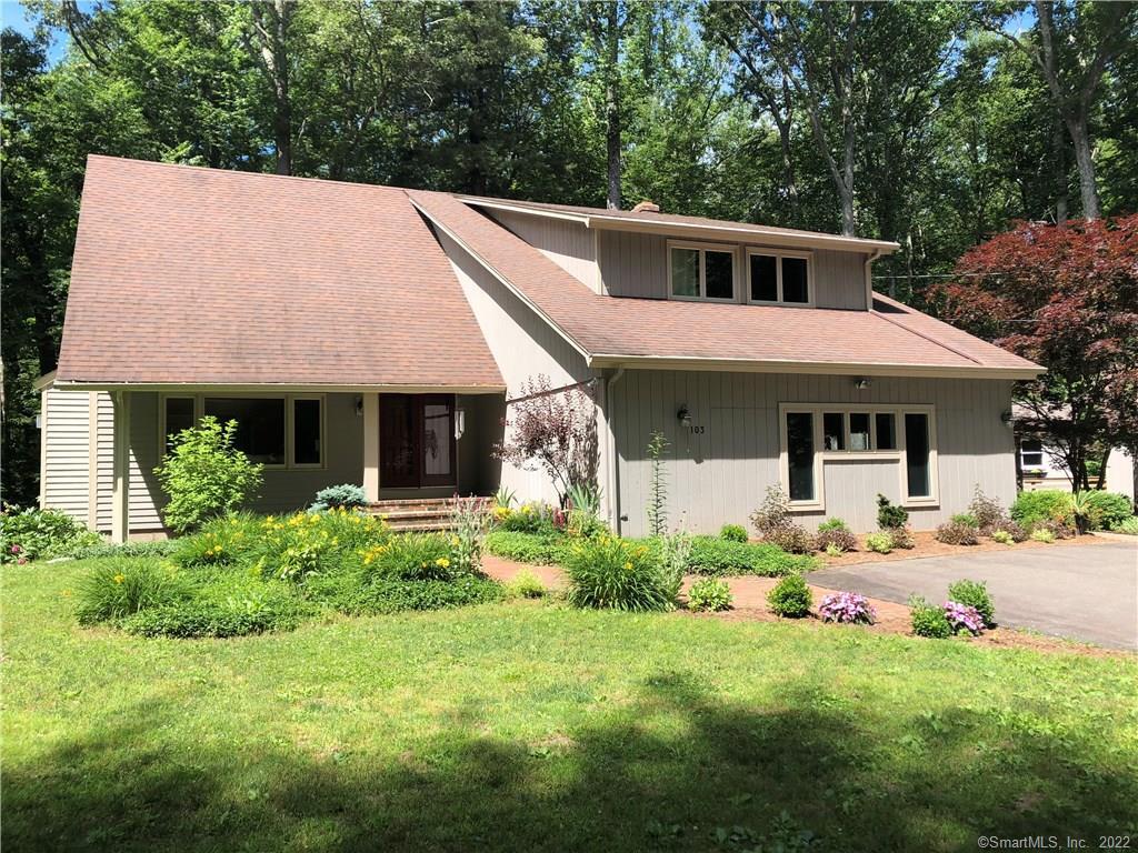 103 Colonial Road Madison, CT 06443 - Photo 1 of 1 a front view of a house with a yard fire pit and outdoor seating