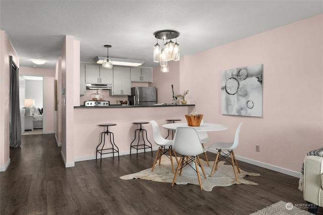 a view of a dining room with furniture and wooden floor