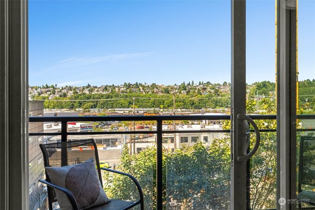 a view of a city from a balcony with furniture