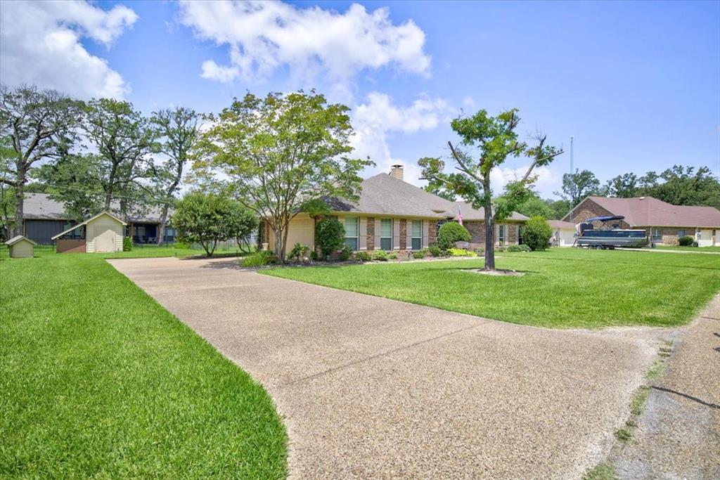 111 Trailwood Road Enchanted Oaks, TX 75156 - Photo 3 of 33 a view of a white house with a big yard and potted plants