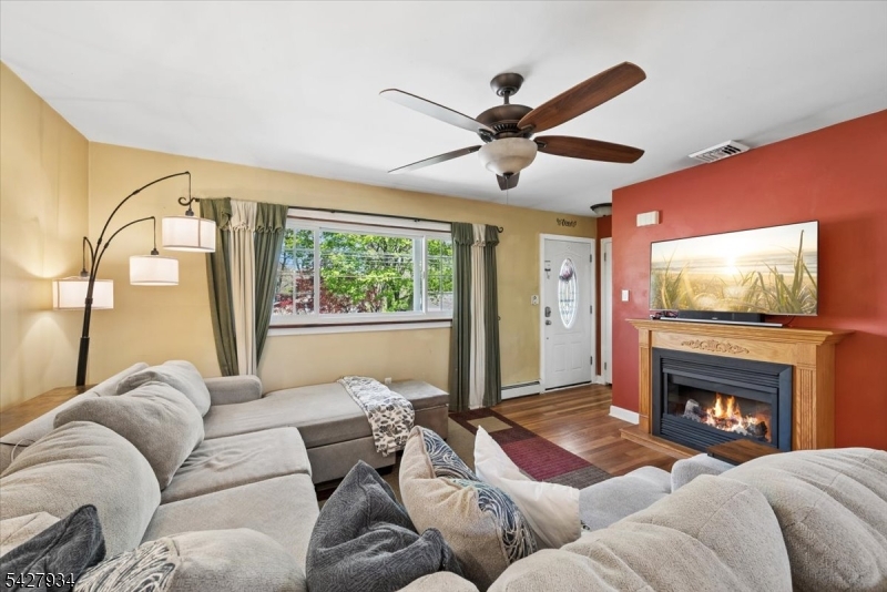 77 Brooklyn Road Stanhope, NJ 07874 - Photo 5 of 27 a living room with furniture fireplace and a flat screen tv