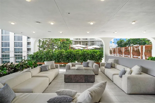 a living room with furniture and a clock