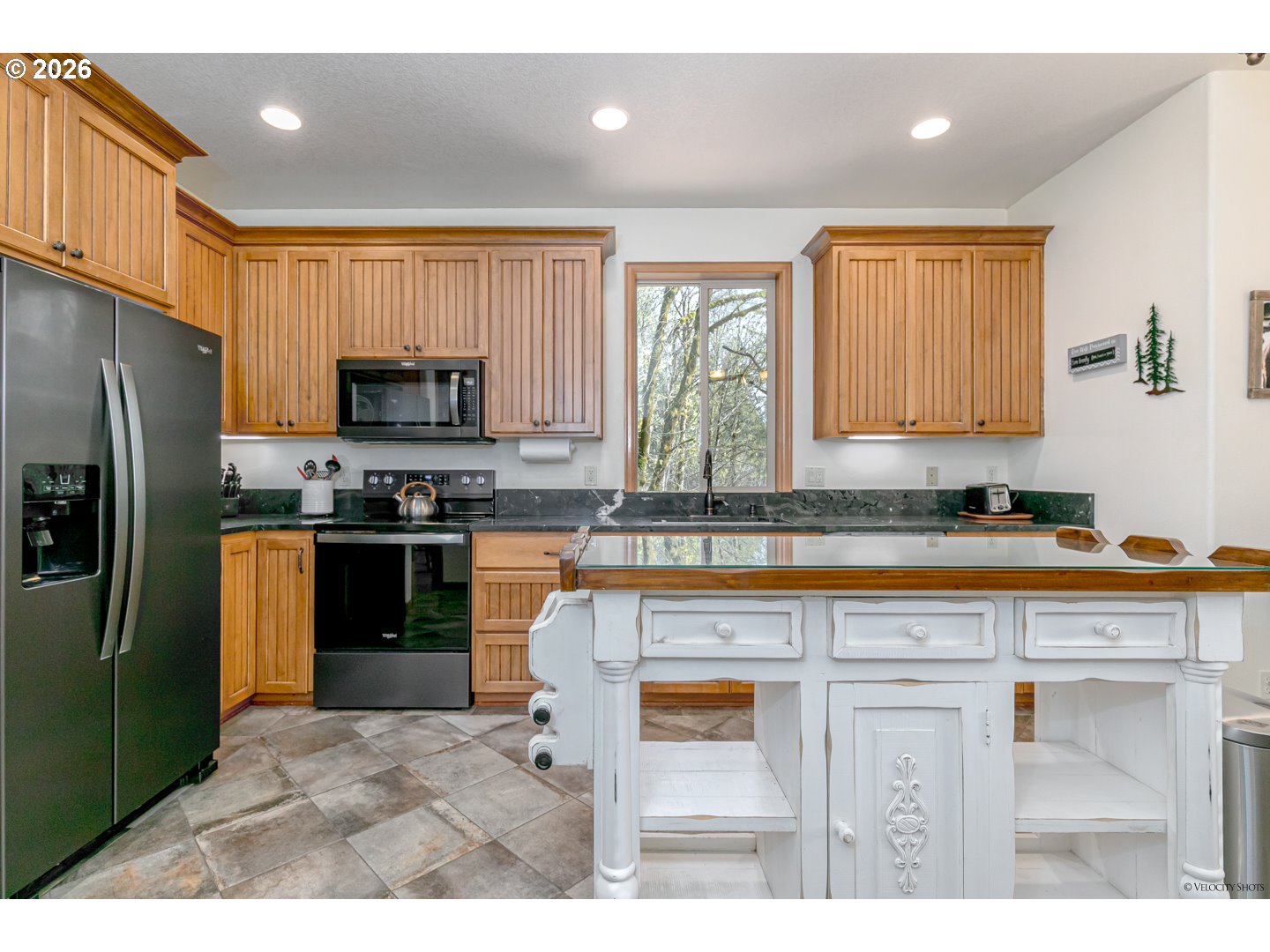 64636 Mc Intyre Road Rhododendron, OR 97049 - Photo 17 of 48 a kitchen with a refrigerator a sink a stove a microwave a counter top and cabinets