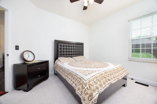 a bedroom with a bed and window