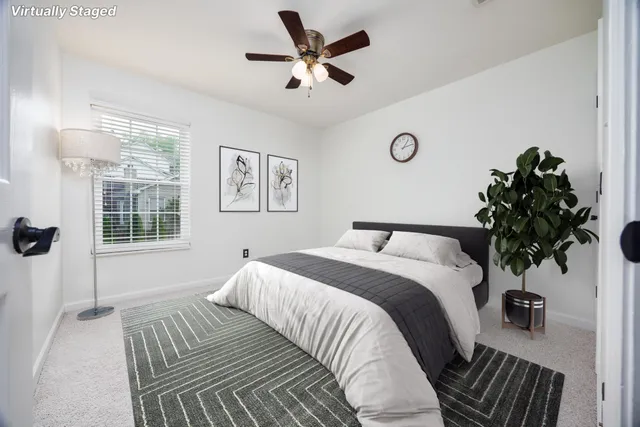 a bed sitting in a bedroom next to a window