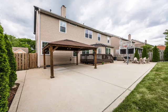 a view of a white house with swimming pool and sitting area