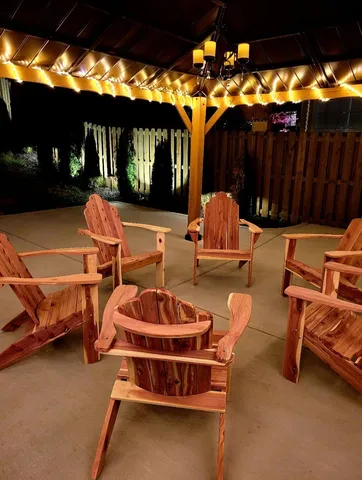 a backyard of a house with table and chairs