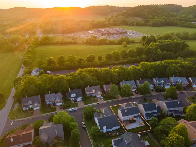an aerial view of residential houses with outdoor space