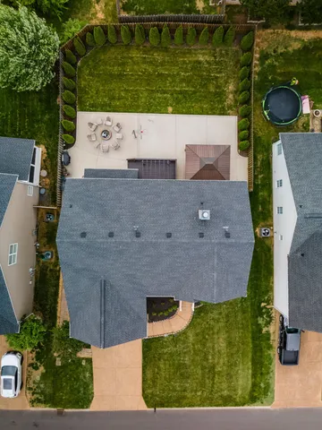 an aerial view of a house with a yard