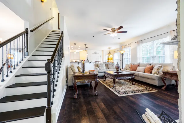 a living room with furniture a rug and a chandelier