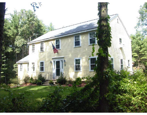 95 Taylor Road Stow, MA 01775 - Photo 1 of 1 a front view of a house with a yard and potted plants