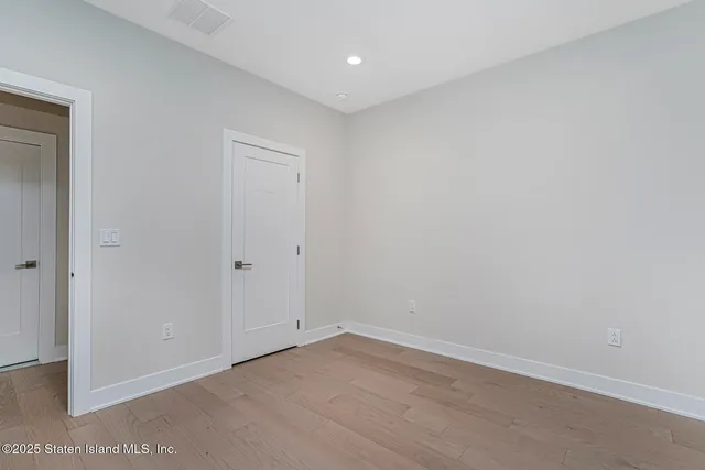 a view of an empty room with a chandelier
