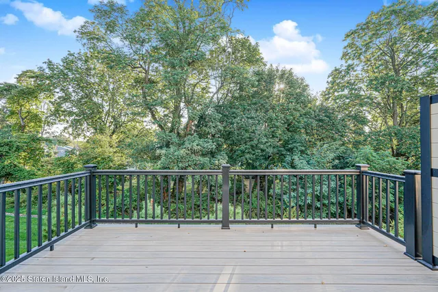 a balcony with wooden floor and fence