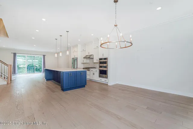a view of kitchen with stainless steel appliances sink