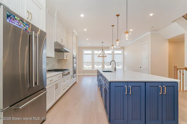 a kitchen with granite countertop a sink stainless steel appliances and cabinets