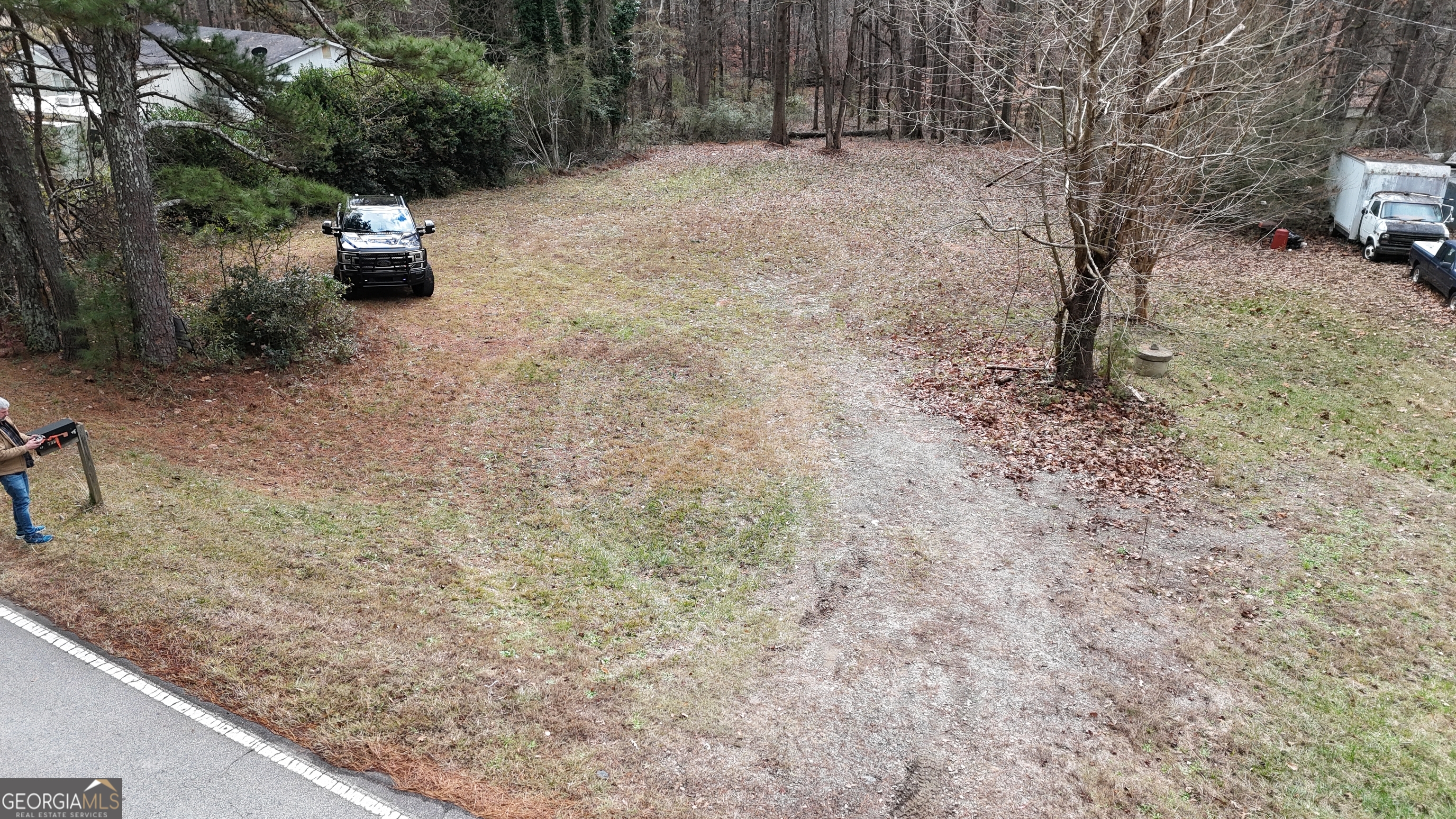 7307 Williams Street Flowery Branch, GA 30542 - Photo 13 of 33 a backyard of a house with lots of green space and trees