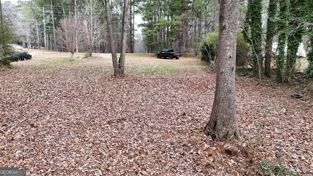 a view of backyard with table and chairs