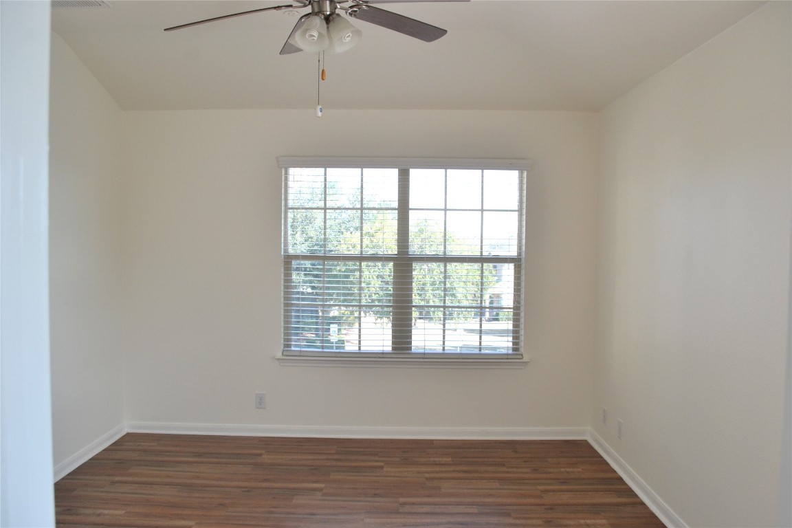 9201 Brodie Lane, Unit 101 Austin, TX 78748 - Photo 14 of 24 an empty room with wooden floor fan and windows
