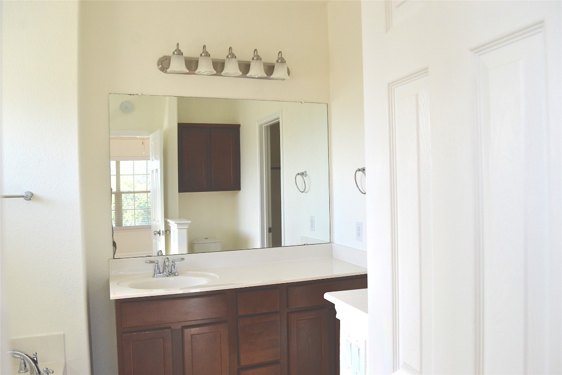 9201 Brodie Lane, Unit 101 Austin, TX 78748 - Photo 17 of 24 a bathroom with a sink and a mirror