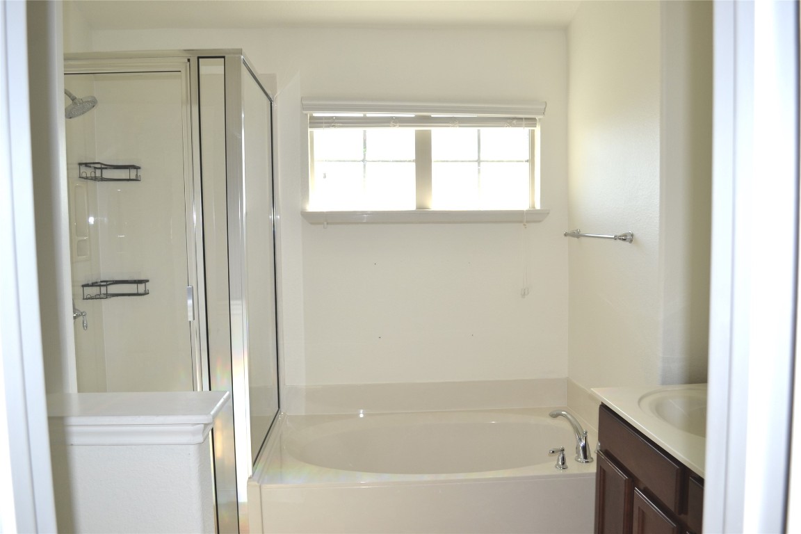 9201 Brodie Lane, Unit 101 Austin, TX 78748 - Photo 18 of 24 a bathroom with a bathtub shower and window